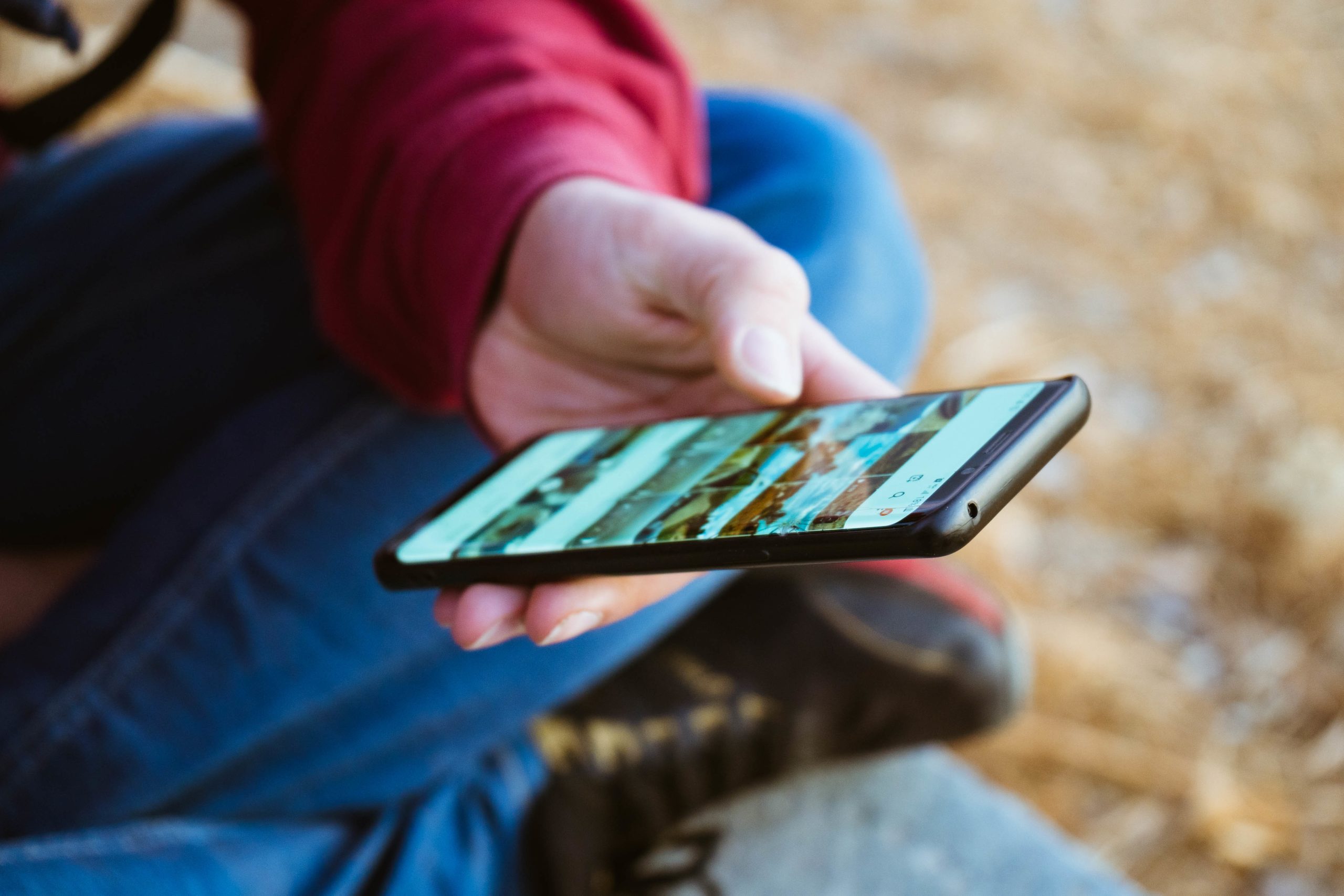 Male Hand Using His Phone Scaled