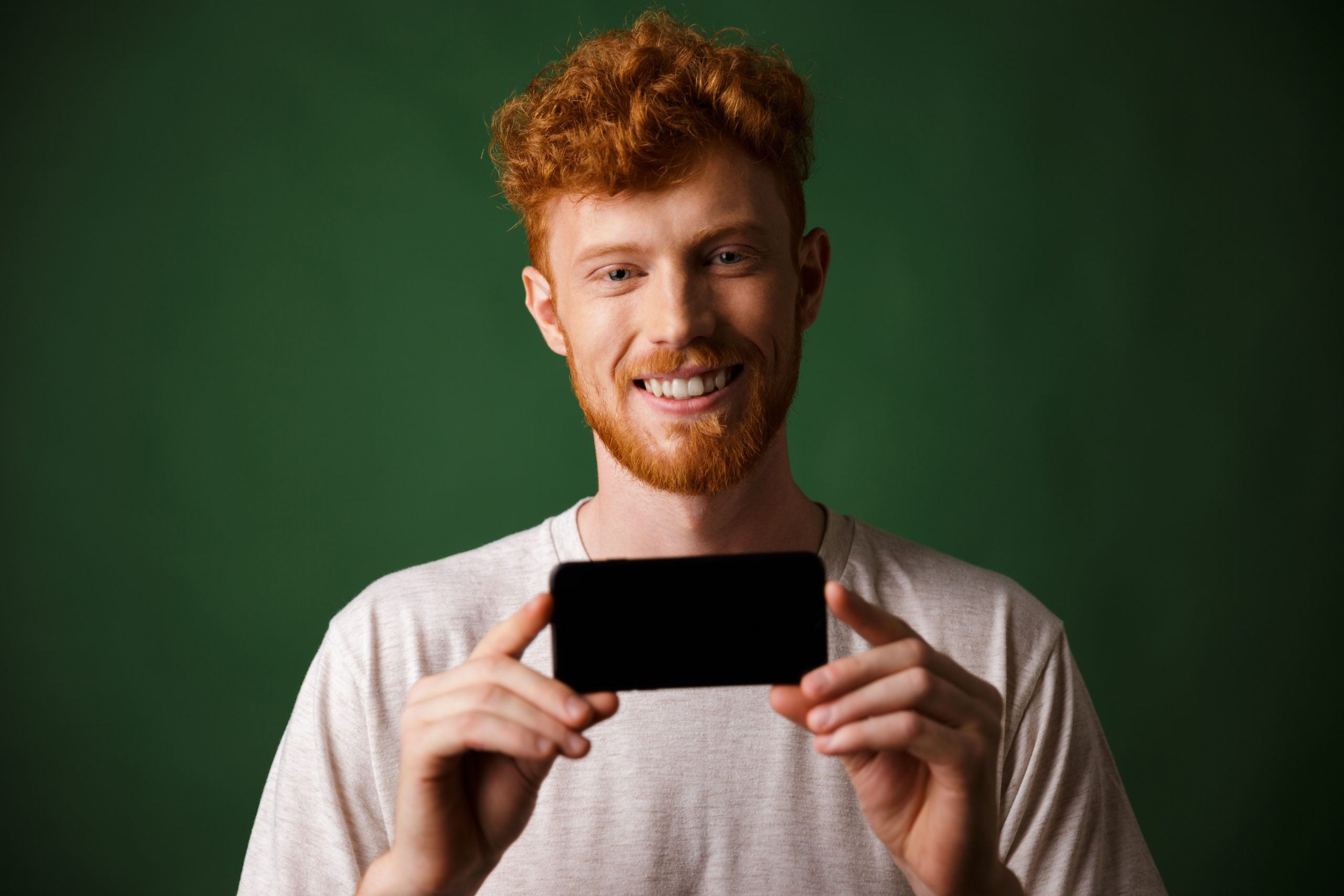 Photo Young Happy Redhead Bearded Man White Tshirt Makes Photo Smartphone Mobile Scaled